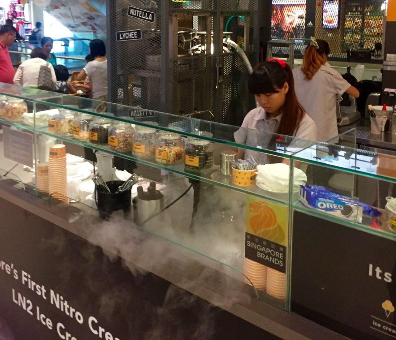 Woman making ice cream with liquid nitrogen.