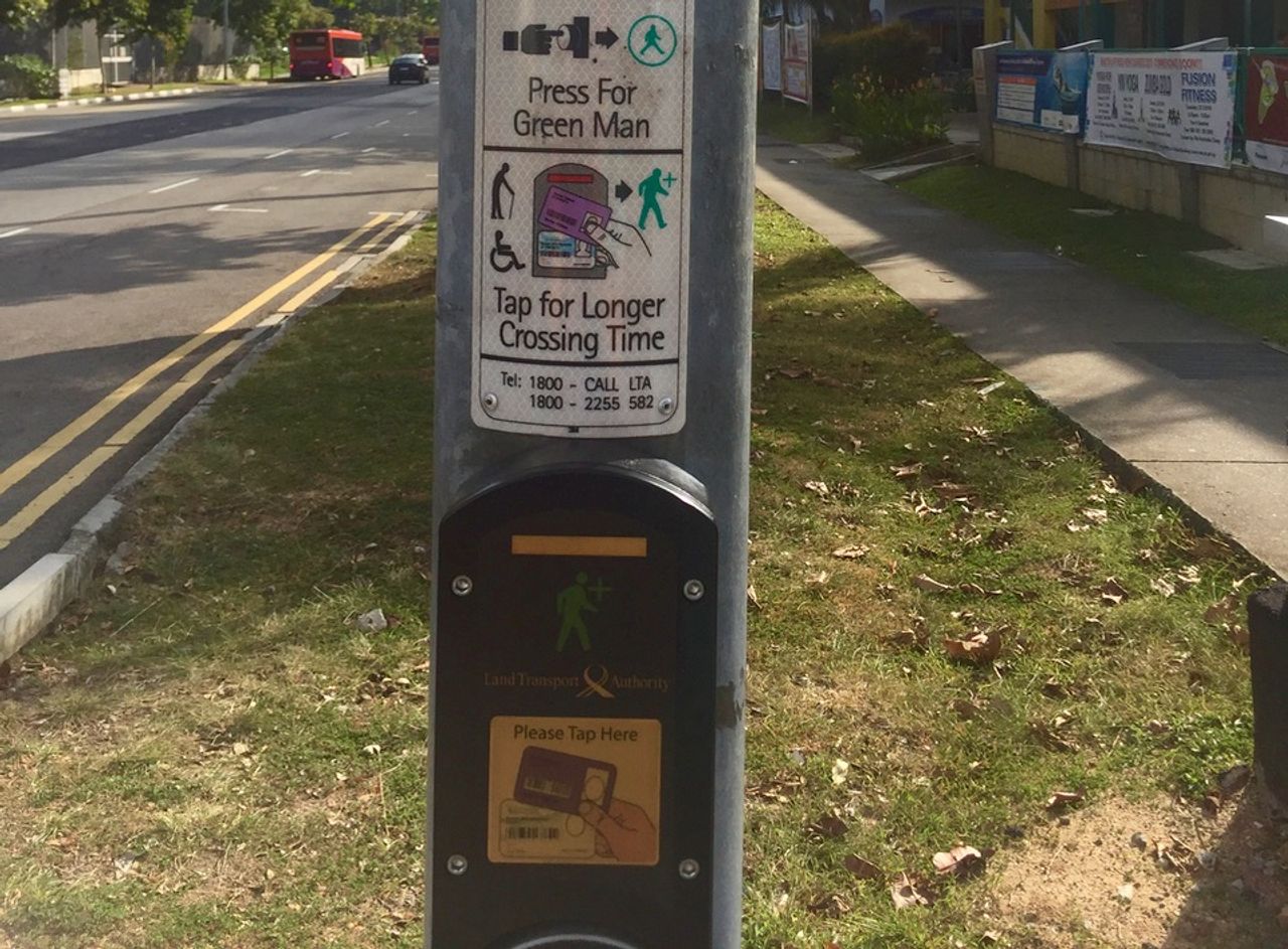Pedestrian crossing with extra instructions for persons with mobility issues.