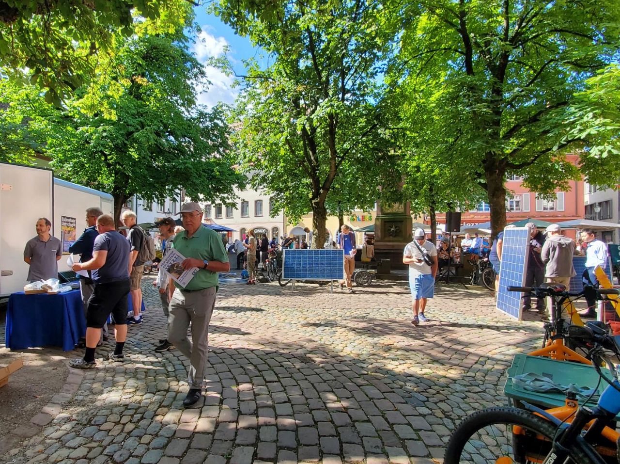 Wide angle photo of the event with a single solar panel standing as an example near the middle of the photo.