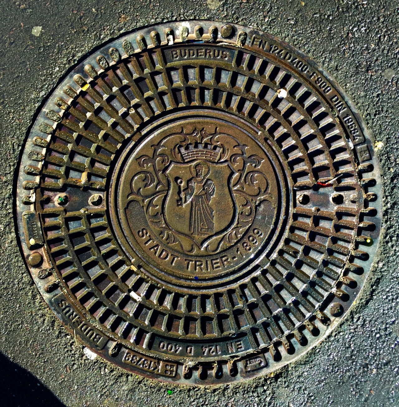 Manhole cover in Trier city center which reads 'Stadt Trier 1899'
