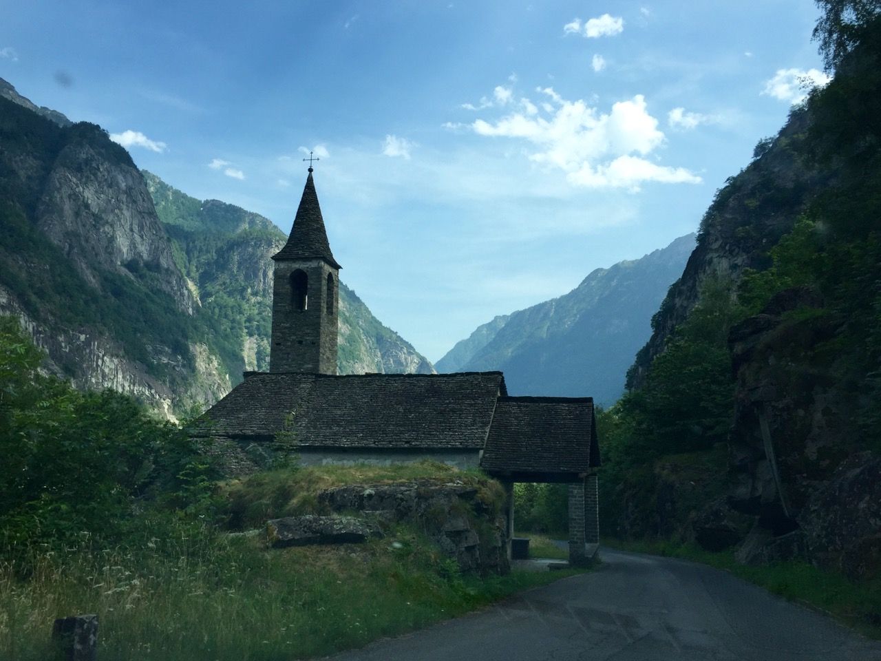An old church on a winding mountain road.