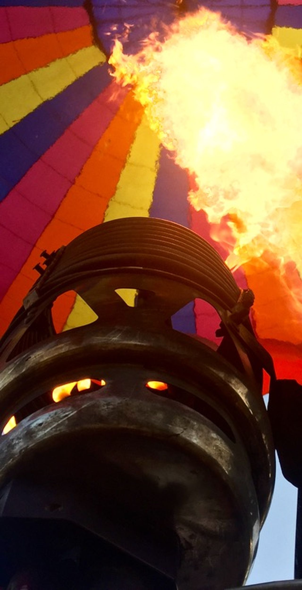Close-up of a flame emitting heat into a hot air balloon.