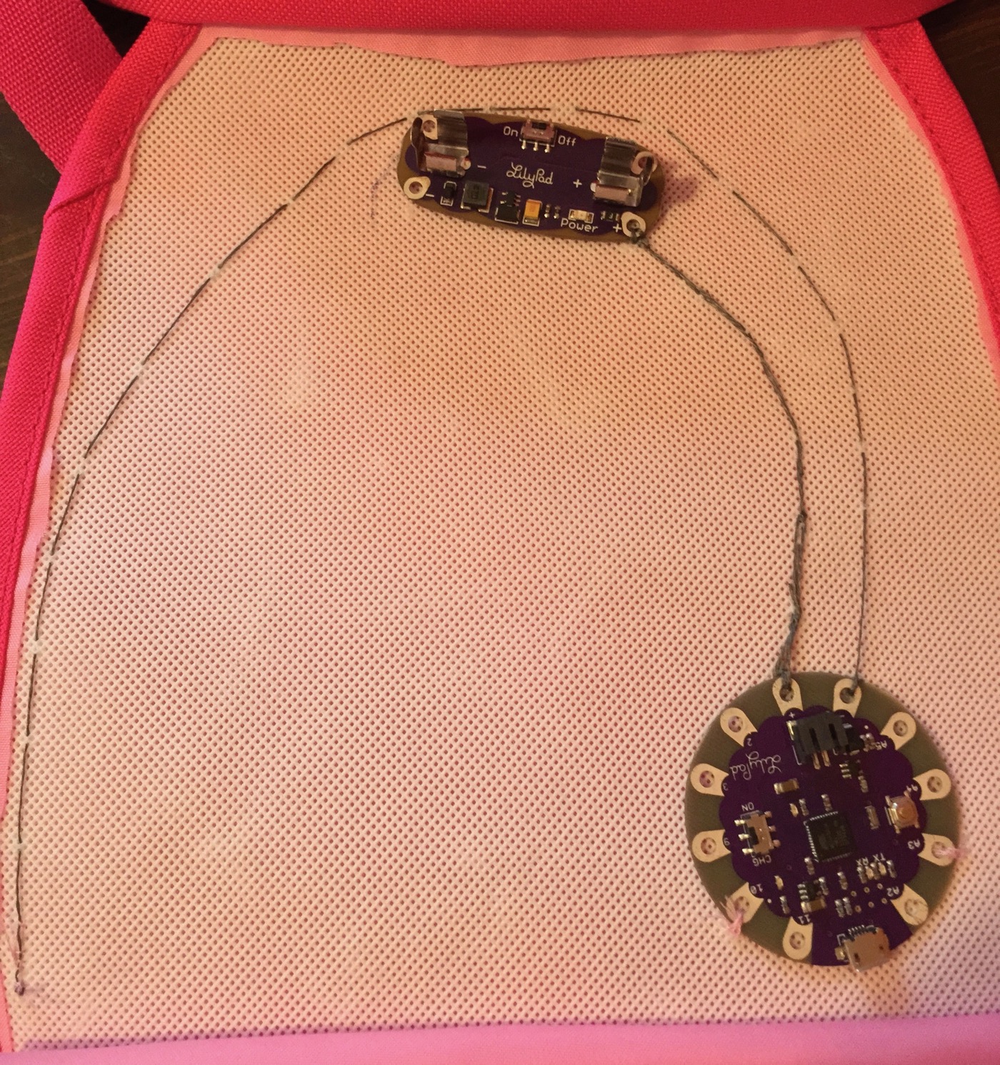 Purse with LilyPad Arduino and battery sewn into place